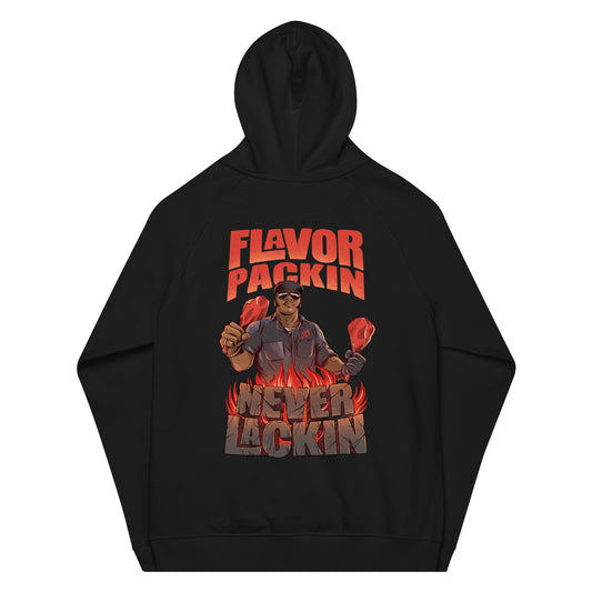 The back of a black hooded sweatshirt with the phrase "Flavor Packin Never Lackin" in red with a man holding two bone in meats over flames